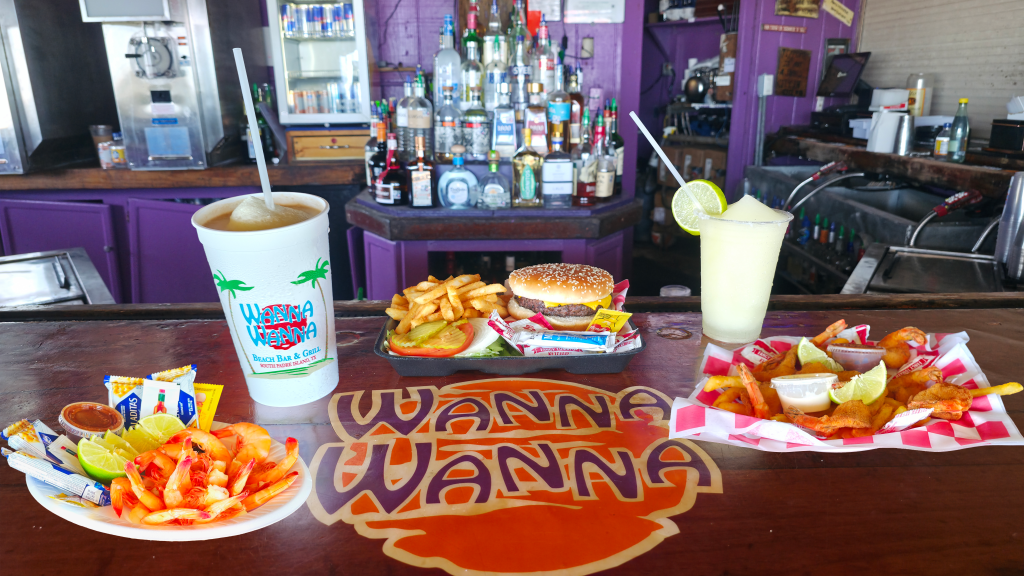 Burgers, fried shrimp, fries and frozen drinks on the bar at Wanna Wanna